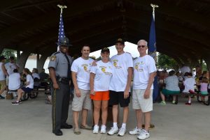 Capt. Maurice A. Tomlinson (from left) poses with Maj. William P. White, director of the state police Bureau of Training and Education; Trooper Samantha Minnucci; her brother Gabriel Minnucci; and Greg Cary, a retired police officer and Camp Cadet board member.