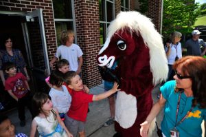 School mascot Chadds the Charger greets students as they come out for May Fair.