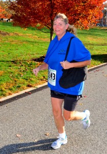Annette Vogts, of Chadds Ford Township, crosses the finish line.