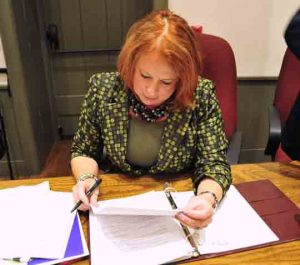 Deborah Love prepares to sign the last batch of bills as a supervisor in Chadds Ford Township.