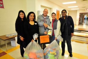 Chadds Ford Elementary School Principal Marc Ransford presents pillows to Kelly O'Leary of Pathways PA. Also shown, from left, are Varsha Godambe-Jain, Ira Tripathi-Zutshi and Seetha Raju from the CFES PTO. 