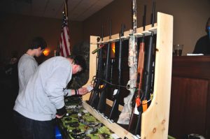 Guests at the wild game dinner check out some of the  weapons that were raffled and auctioned off. The money raised benefits the Chester County Sheriff Department's canine unit.