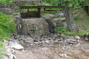 Without water flowing through the millrace, the small water fall at the park looks as if someone has turned off the spigot.