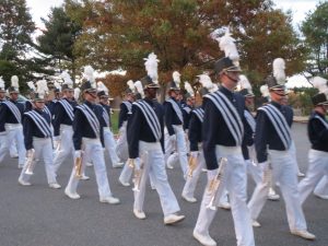 Members of the Downingtown West High School band march toward the Unionvile High football field to start the competition.