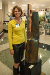 Featured artist Karen Delaney with one of her sculptures. She was donating 100 percent of the sale price for five of her pieces during the UHS Arty Gala.