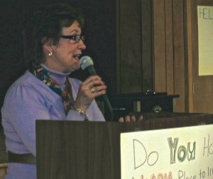 Longtime community advocate Joan Holliday urges the audience to participate in the activities planned for National Hunger and Homelessness Awareness Week.