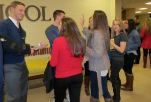 After the memorial service, friends congregate in the hallway to continue sharing memories of Andy Joseph.