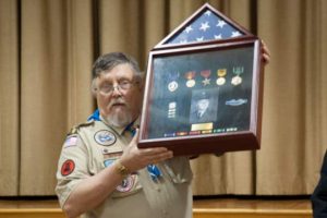 Scoutmaster Ray Coe holds a display case with the medals he earned while serving with the U.S. Army during the Vietnam War. The display was presented to him during a medal ceremony on Dec. 1.