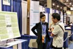 Shashwat Kishore (left) is shown discussing one of his mathematics projects at the 2013 Intel International Science and Engineering Fair in Phoenix, Az.