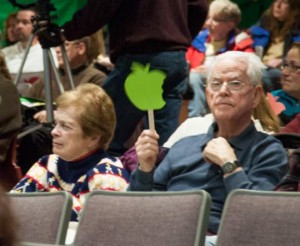 People attending the meeting would wave red or green apple-shaped placards to show approval or disapproval on what was being said. Green is approval.