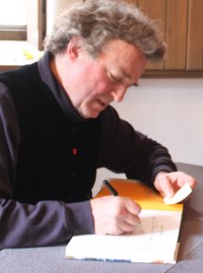 Jamie Wyeth signs catalogues for his retrospective during a marathon autograph session on Saturday at the Brandywine River Museum of Art.
