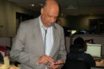 Chester County Commissioners' Chairman Terence Farrell demonstrates the new 9-1-1 texting system implemented by the county. To his right is dispatcher Shana Howard.