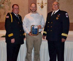 Telecommunication of the Year winner Steven Bacharach is flanked by Keith Johnson (left), president of the EMS Council, and John Applegate, the council's vice president.