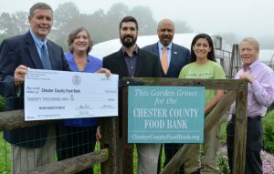 Larry Welsh (from left), executive director of the Chester County Food Bank; County Commissioner Kathi Cozzone; Norm Horn, director of advancement at the Chester County Food Bank; County Commissioners’ Chairman Terence Farrell; Raina Ainslie, Chester County Food Bank raised bed garden manager; and Bob McNeil, founding chairman of the Chester County Food Bank, gather for the check presentation.