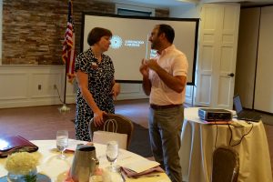 Longwood Gardens' representatives Patricia Evans (left) and Nick D'Dazzio confer before addressing the Southern Chester County Chamber of Commerce.