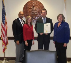 Chester County Commissioners Terence Farrell (from left), Michelle Kichline and Kathi Cozzone (right) present Recorder of Deeds Rick Loughery 