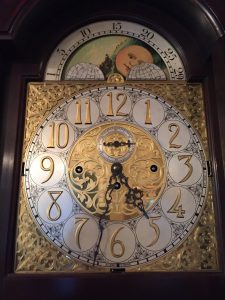 Karen Ammon, vice-president of the Kennett library board, says the intricate details in this 1911 tall-case clock prompted the board's decision to remove it during renovations to the building. Photo by Karen Ammon