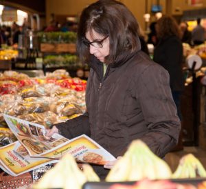 Rena Cuno of Chadds Ford checks out the Wegmans store circular on opening day.
