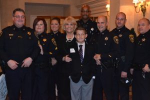 Alex Collins poses with Chester County Sheriff Carolyn 'Bunny' Welsh (center) and a group of deputy sheriffs at the Youth Mentoring Partnership dinner on Thursday, Nov. 