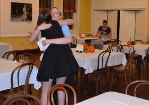 Before leaving the pre-lecture reception, Victoria Wyeth stops to hug all of the servers.