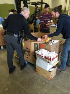 Trooper Pascal DiJoseph unloads donations from the Avondale barracks at the Chester County Food Bank.