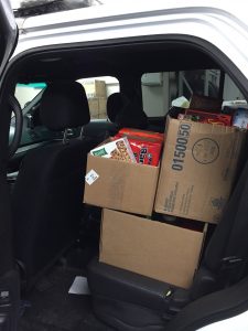 Troopers at the Avondale barracks load 380 pounds of food into one of the patrol SUVs. The barracks hopes to amass even more donations for a delivery at Christmas.