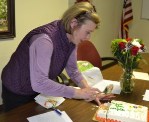Supervisor Georgia Brutscher cuts the cake she received for her nearly 30 years of service to Pocopson Township.