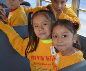 Wide-eyed students from the Chester County Family Academy sit on the bus that will take them to Walmart for their holiday shopping odyssey.