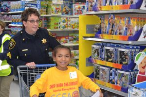 Deputy Sheriff Barb Marciano heads down one of the Walmart aisles with an eager shopper.