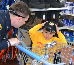 Deputy Sheriff Mike Cabry temporarily loses his hat during a shopping spree with a student from Chester County Family Academy.