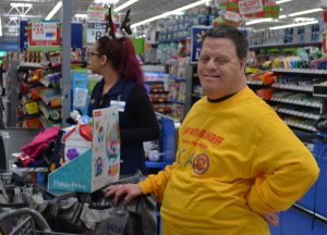 Tommy Potts (right) is known as one of the event's best volunteers. Behind him is Walmart cashier Nashaly Trinidad.