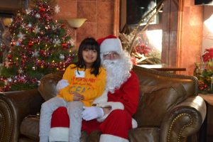 A young guest from the Chester County Family Academy enjoys a visit with Santa during 'Shop with the Sheriff.'