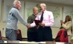 Kennett Township Supervisor Bob Hammaker accepts a comparative plaque from Supervisors' Chairman Scudder G. Stevens as Township Manager Lisa M. Moore (right) and Supervisor Richard L. Leff applaud his service.