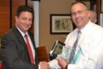Jose Reyes (left), board president of the Chester County Crime Victims' Center, congratulates West Goshen Det. David Maurer, one of the co-recipients of the 2015 John J. Crane award for victim advocacy.