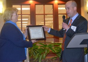 Outgoing Historic Kennett Square Board President David B. Myers presents a certificate of appreciation to Carrie Freeman for her board service.