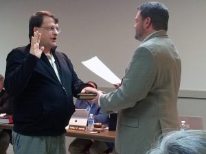 Newly appointed Borough Councilman Ethan Cramer (left) is sworn in by Kennett Square Mayor Matt Fetick.