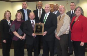 Chester County Detective Lt. Michael McGinnis (clockwise from top left), Commissioner Terence Farrell, Chief County Detective Kevin Dykes, First Assistant District Attorney Michael No-one, Commissioner Kathi Cozzone, Pat Davis, District Attorney Tom Hogan, DES Director Robert Kagel, Chrissy DePao, and Commissioner Michelle Kichline applaud the county's proactive training efforts.
