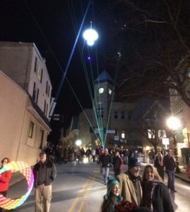 The crowd for the Third Annual Midnight in the Square watches as laser lights and the illuminated mushroom set the borough of Kennett Square aglow.