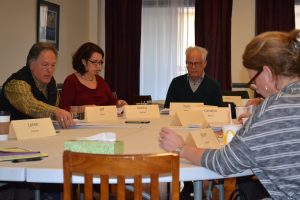 Before the library board meeting, Jeff Yetter (from left), the board's vice-president; director Donna Murray; Board President Tom Swett; and board member Karen Ammon review materials. 