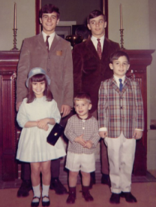 Andrew Tavoni (center, front row) poses with his siblings at The Fussell House.