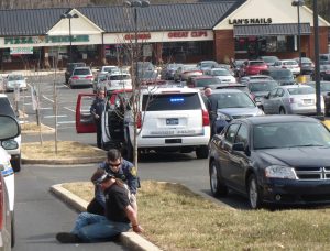 One of the unidentified occupants of a truck with improper registration is taken into custody on an outstanding warrant at the Westtown Village Shopping Center