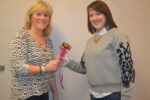 Outgoing Unionville Community Fair President Danielle Chamberlain (left) passes the gavel to her successor, Deb Deckman.