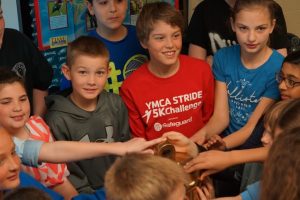 Pocopson Elementary fifth-graders enjoy touching the brass bell that once tolled on the ill-fated Andrea Doria.