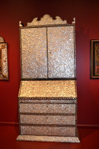 A desk and bookcase from 18th-century Peru features mother-of-pearl and tortoiseshell inlays, Spanish cedar, mahogany, gilding and oil painting.