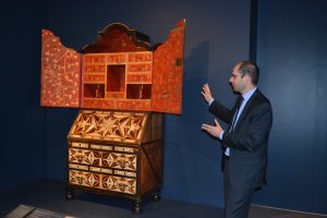 Curator Dennis Carr points out the intricacies of a mid-18th-century desk and bookcase that contains myriad global influences.