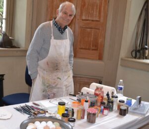 Artist Terry Wolf says he enjoys sharing the magic of mixing tempera paints.