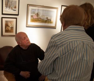 Water colorist Ray Hendershot talks with some fans during the opening of his exhibit at the Chadds Ford Gallery on April 15. The exhibit, “My World — Chapter Three,” runs through May 1.