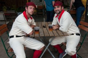 Cap 1: Matt Ticknor, left, and Michael Kelly, of the Kennett Square Mohicans are in their old style uniforms in honor of Theodore Pennock, one of the brothers who founded the original creamery in 1902 and who played with the original Kennett Square Mohicans. The current team plays “1864” style baseball with the old rules where pitching is underhand and a batter is out if an infielder catchers a groundball on one bounce.