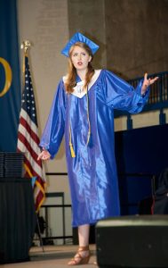 Clarisse Cofransesco recites a poen, "Open the Door," that she wrote for the graduation.