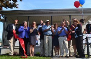 Officials applaud after Melanie Weiler cuts the ribbon for the KACS Resource Center.